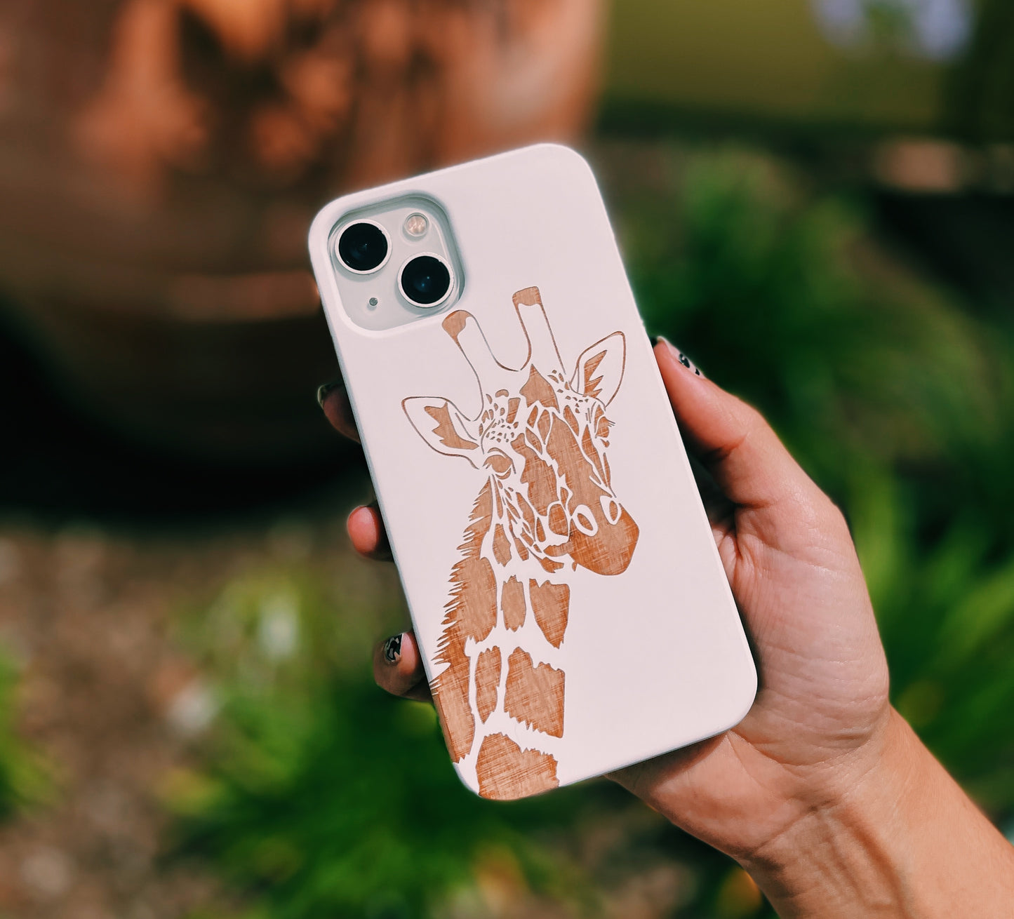 Eco-friendly wooden iPhone case with a detailed laser-engraved Giraffe, MagSafe-compatible for easy wireless charging