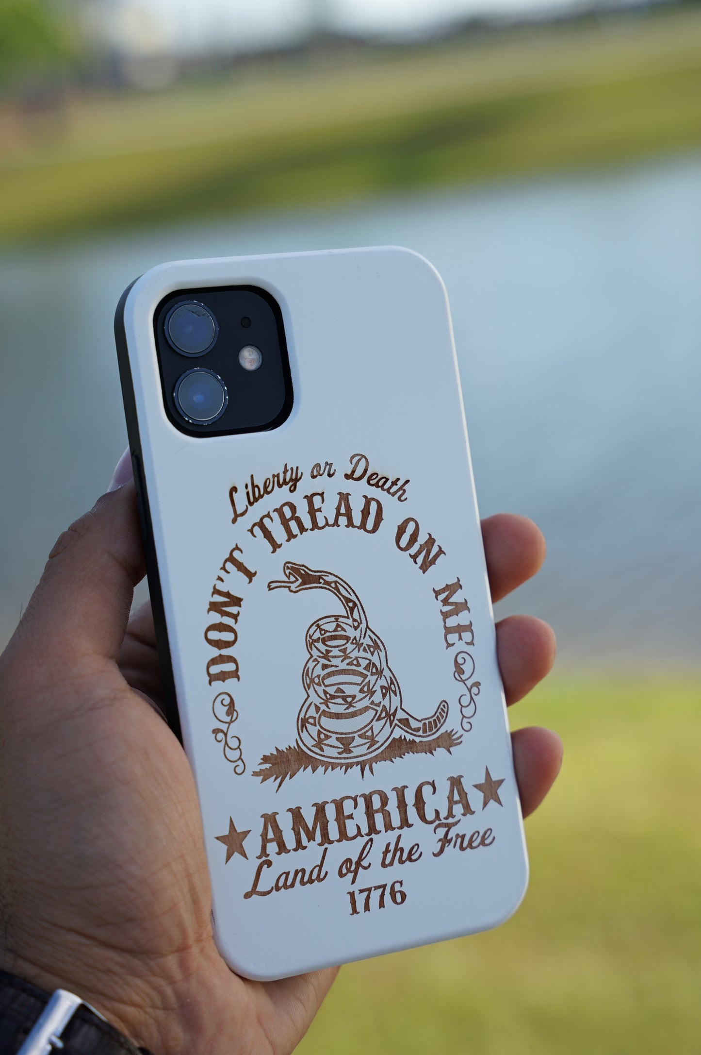 Eco-friendly wooden iPhone case with a detailed laser-engraved Don't Tread On Me design, MagSafe-compatible for easy wireless charging